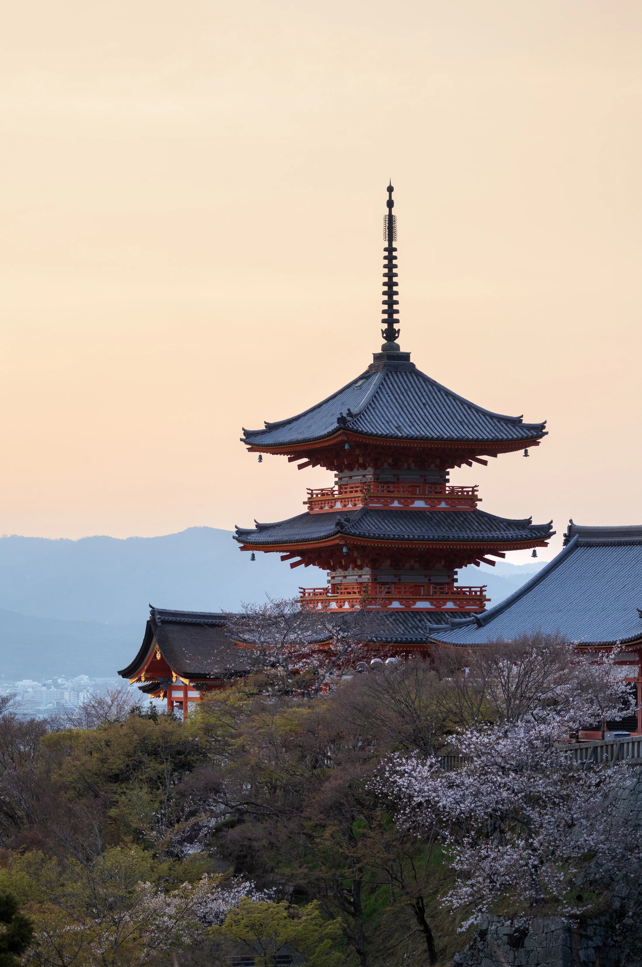 A Kyoto pagoda beneath a warm sunset sky